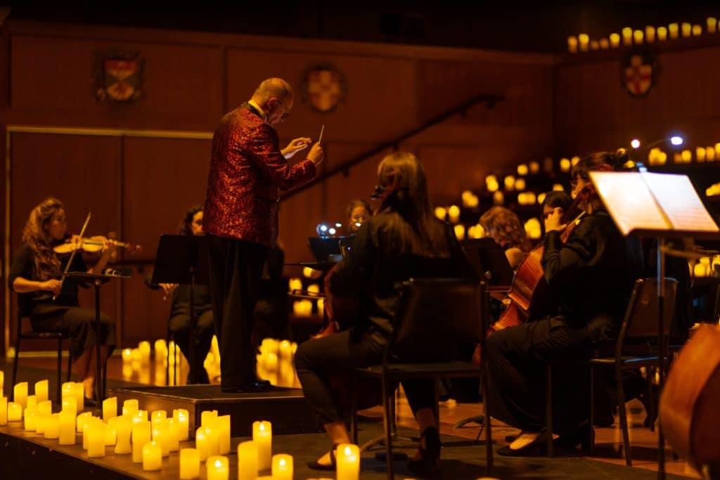 conductor and orchestra performing at Candlelight concert