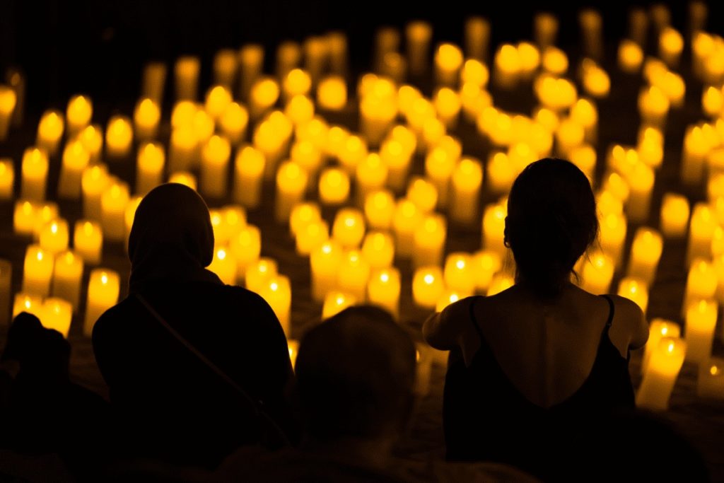 A silhouette of a couple in the audience of a Candlelight concert