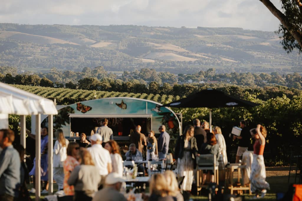 Open-air festival in McLaren Vale wine region with panoramic hilly views across vineyards