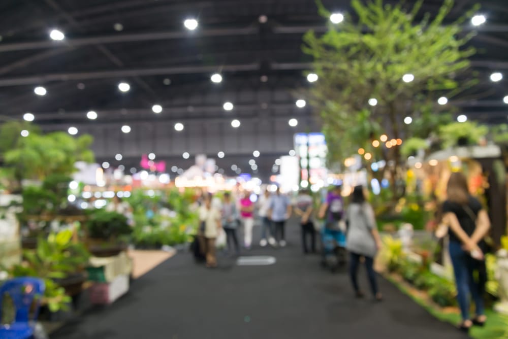 People walking around an indoor gardening expo