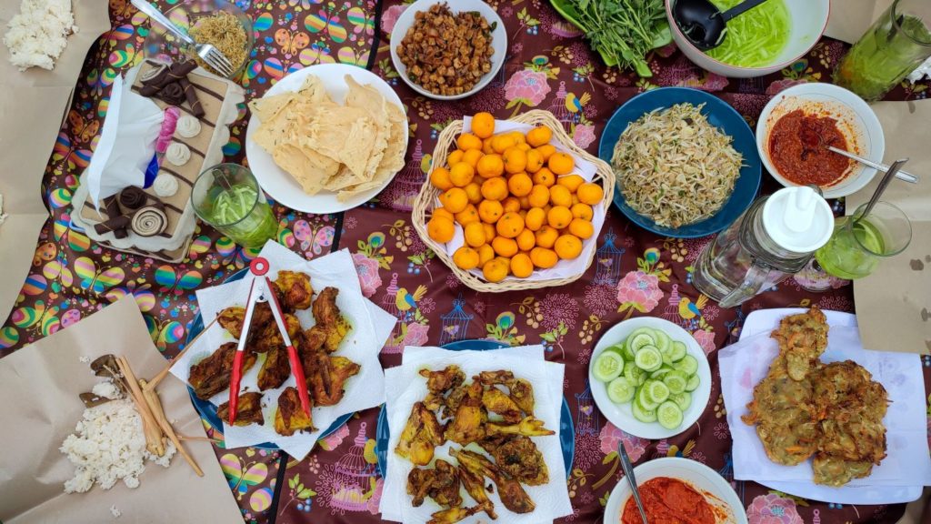 Spread of Indonesian food across big table