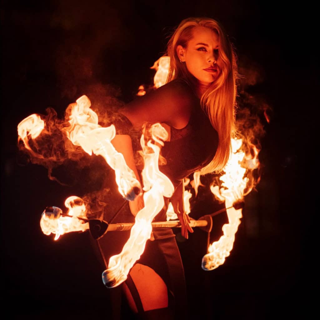 Fire dancer spinning six flames