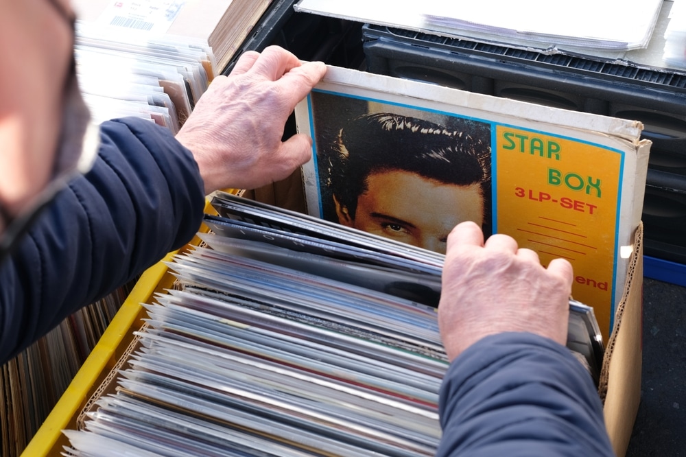 Close up of someone's hands, flicking through a box of records