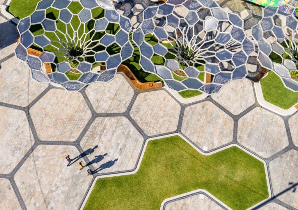 Birdseye view of an urban space with tessellating paving and metal trees