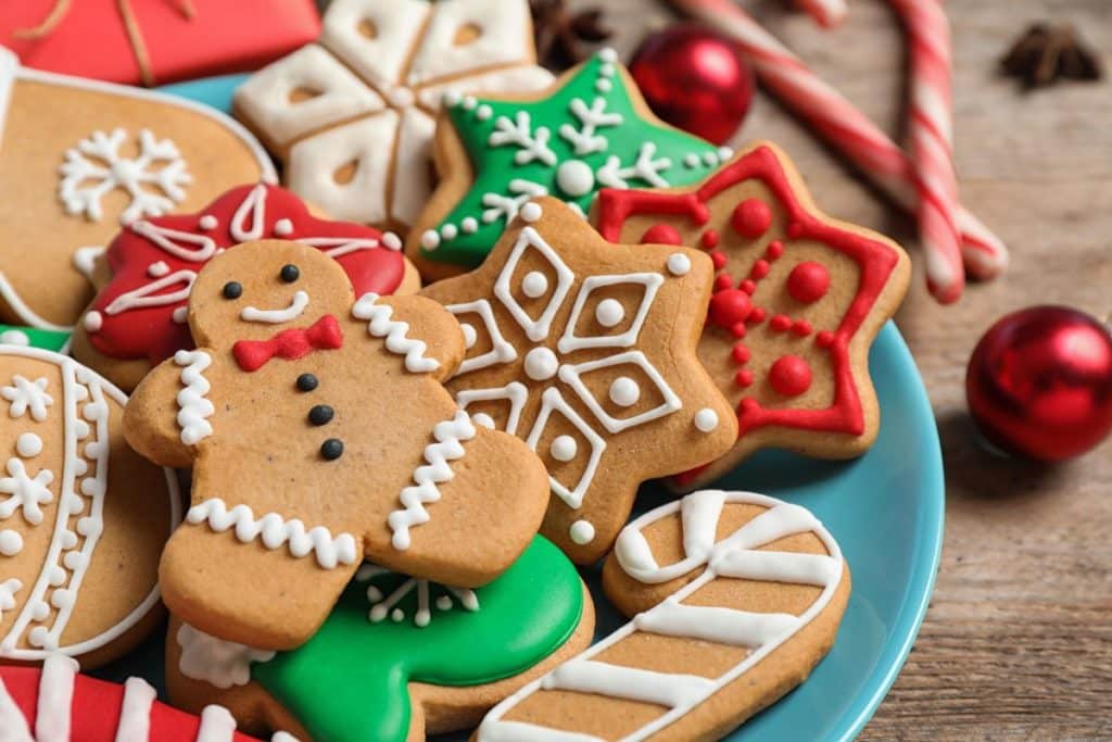 Plate piled with Christmas-themed cookies with a gingerbread man front and centre